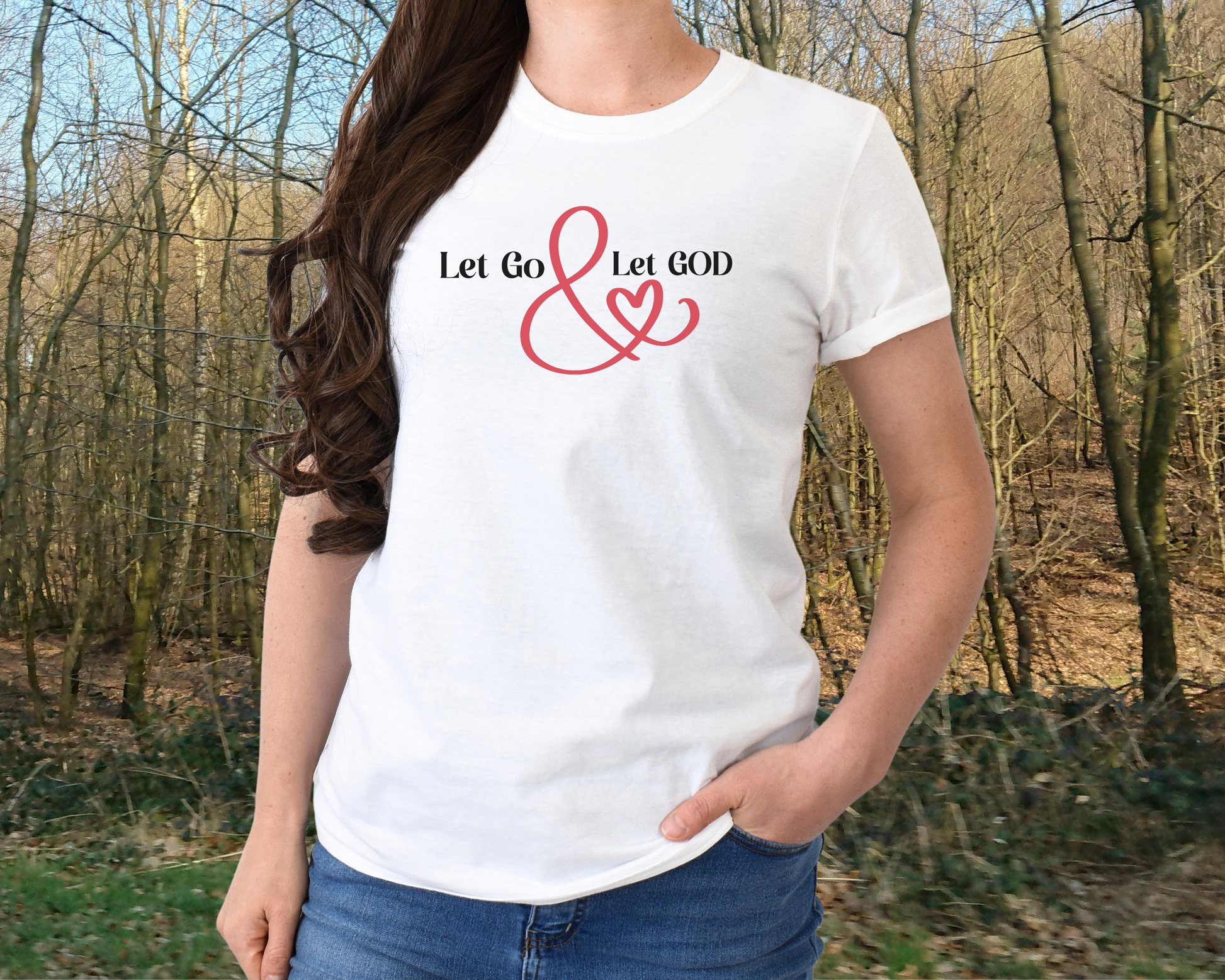 White t-shirt with the phrase ‘Let Go & Let God’ in bold black text and a red ampersand forming a heart. Cozy, inspirational faith-based apparel for everyday wear.